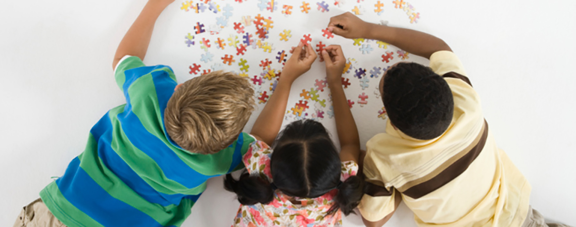 Children Working on Jigsaw Puzzle